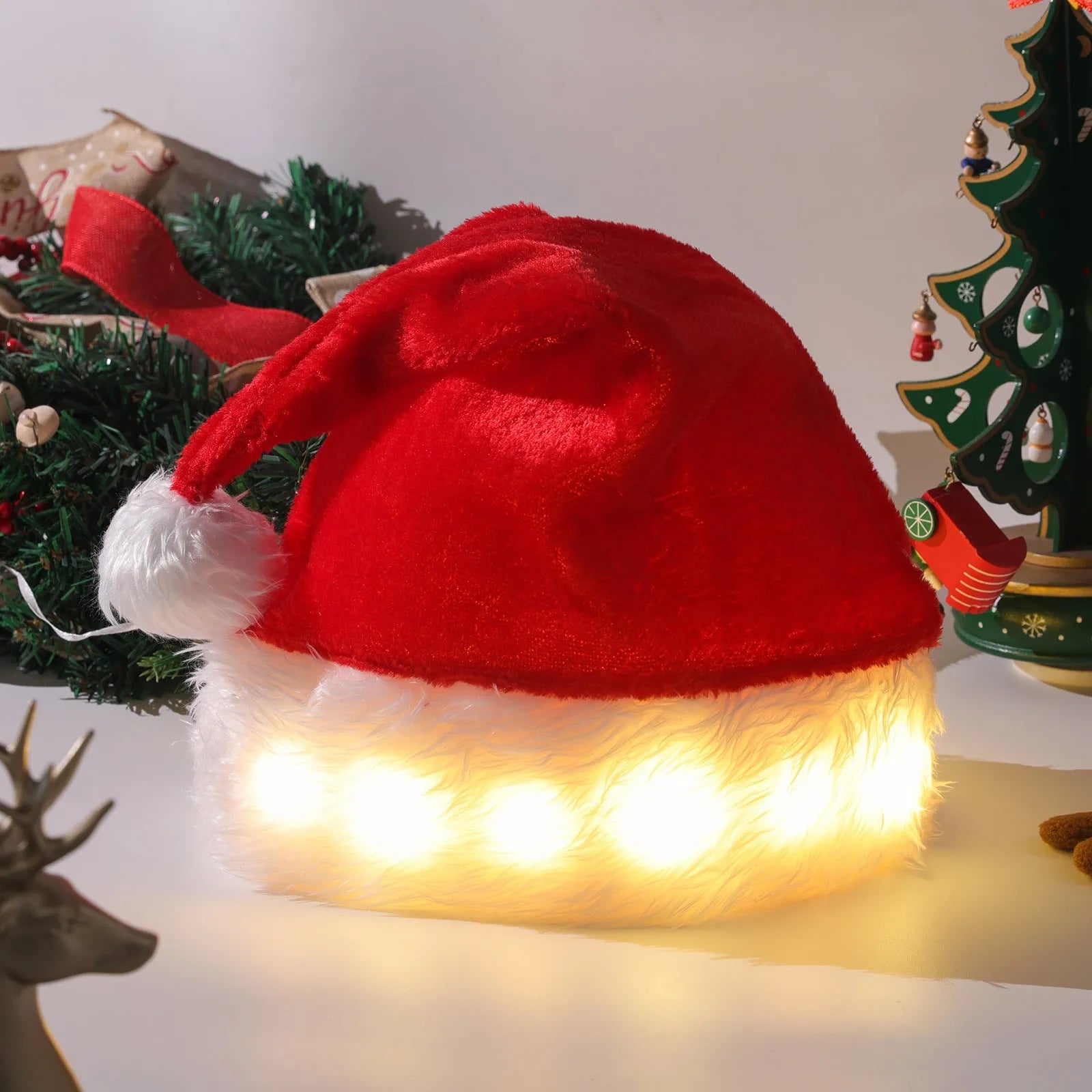 Red and white plush Santa hat with integrated twinkling LED lights and a white pom-pom.