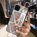 Rose flower pattern iPhone case with an integrated fabric wrist strap for hands-free carrying.