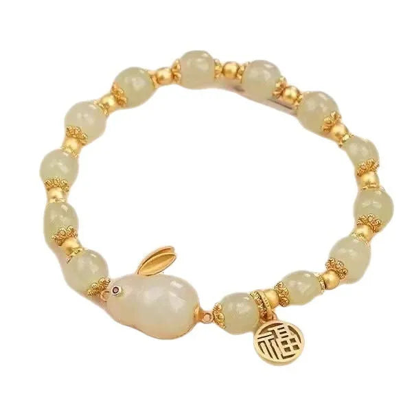 Women's green jade bracelet with fu character hare pendant and lily element on black adjustable cord