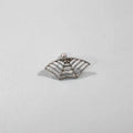 Spider web pattern stud earrings in gold and silver electroplated metal.