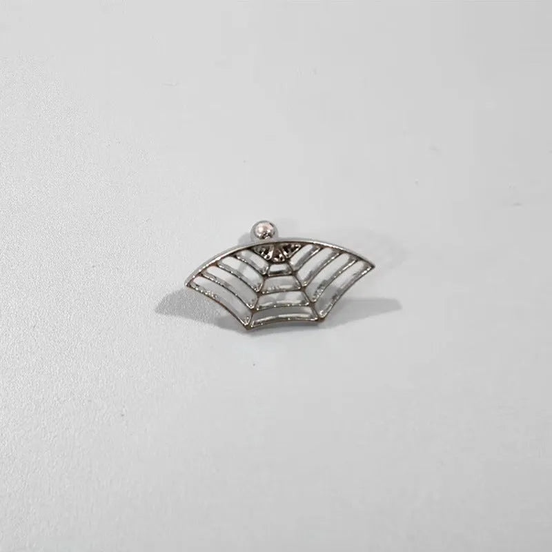 Spider web pattern stud earrings in gold and silver electroplated metal.