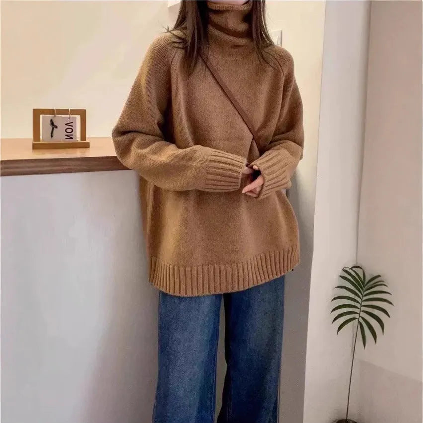 Women's loose grey turtleneck sweater with a thick knit and textured curling pile collar.