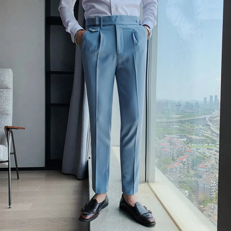 Men's straight-leg casual trousers in solid colours including black and grey, laid flat.