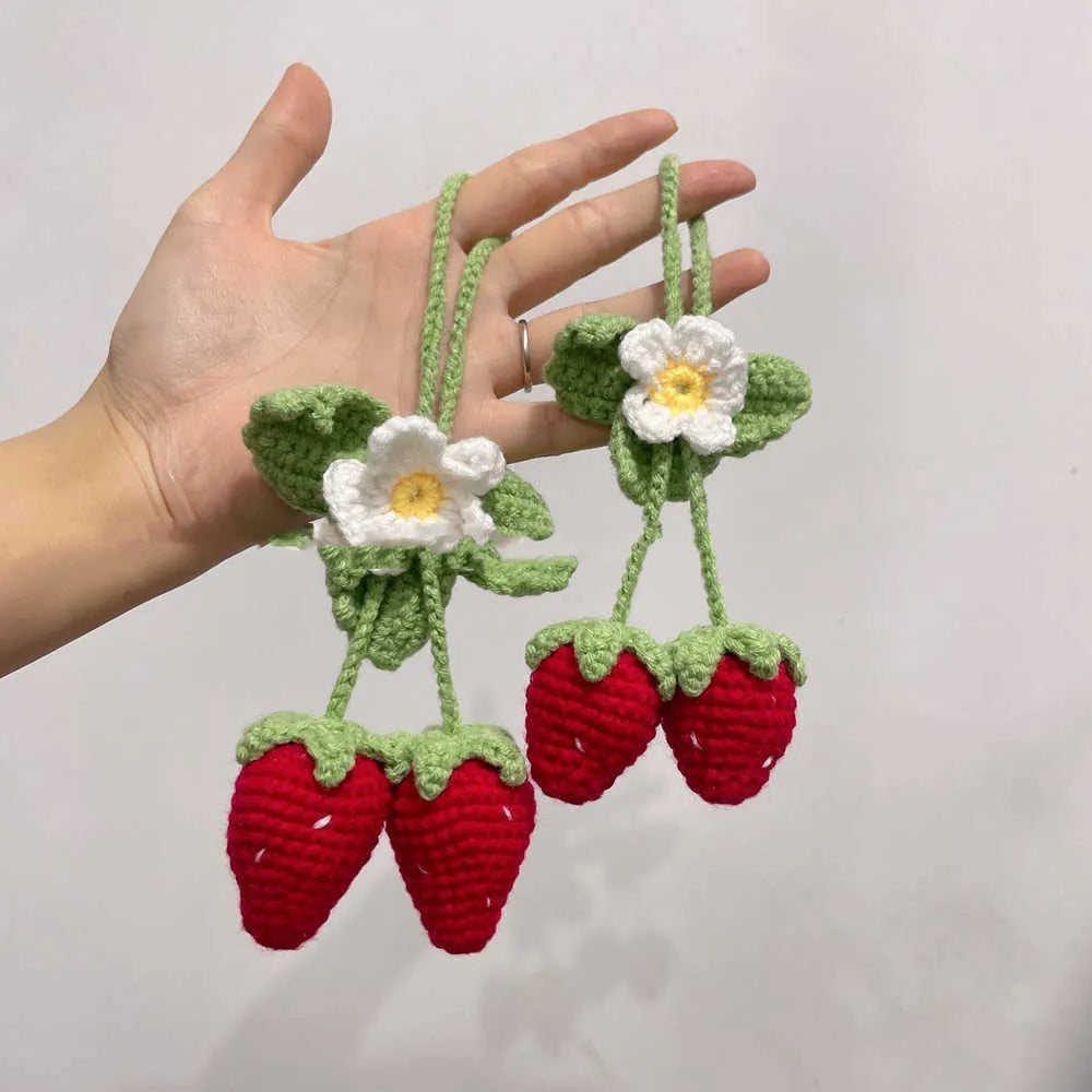 Handwoven strawberry-shaped car pendant made from natural cotton and hemp fibres.