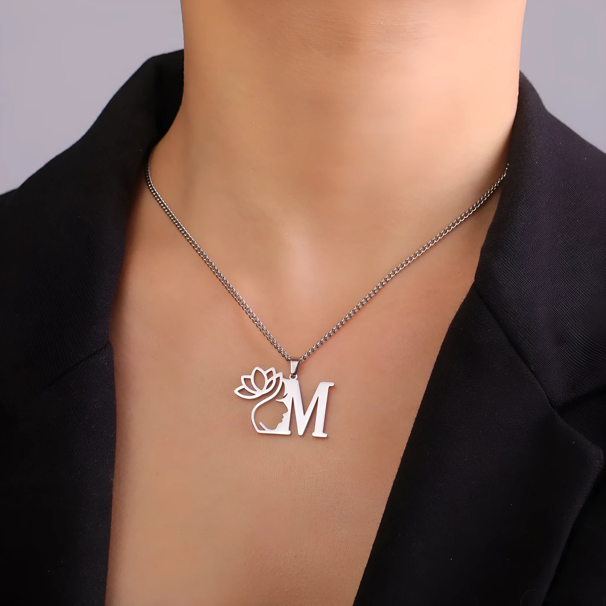 Stainless steel necklace with cross chain and a single initial pendant in gold or silver tone.
