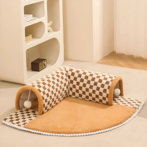Coffee-coloured plush pet bed with attached tunnel showing soft sleeping area and play space