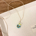 Women's pendant necklace with coloured glaze joker charm on cotton linen chain