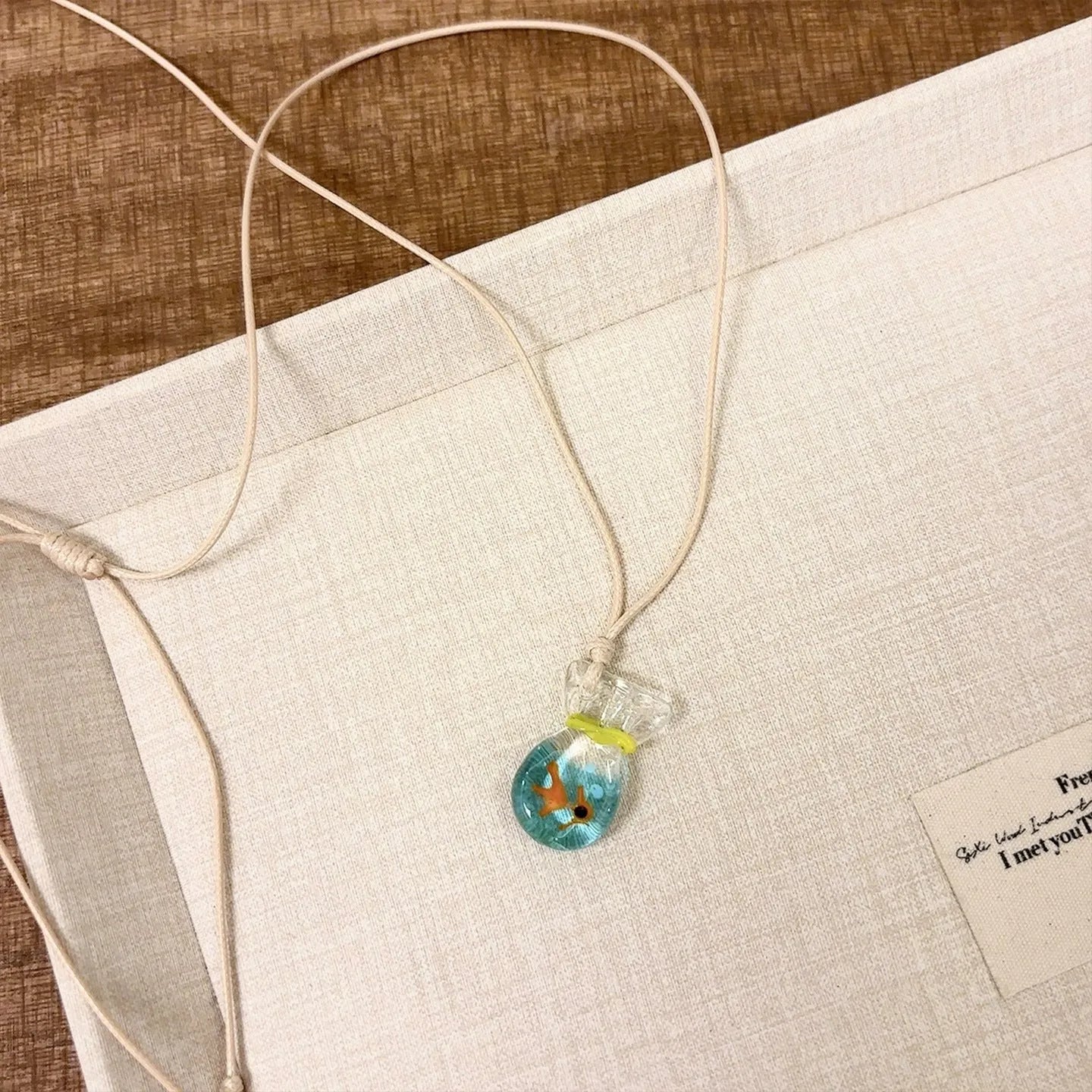 Women's pendant necklace with coloured glaze joker charm on cotton linen chain