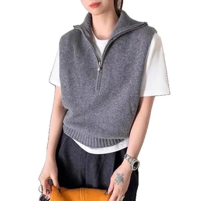Retro half-zip sleeveless knit vest in mesh fabric, shown in orange colour with a 3D pattern.