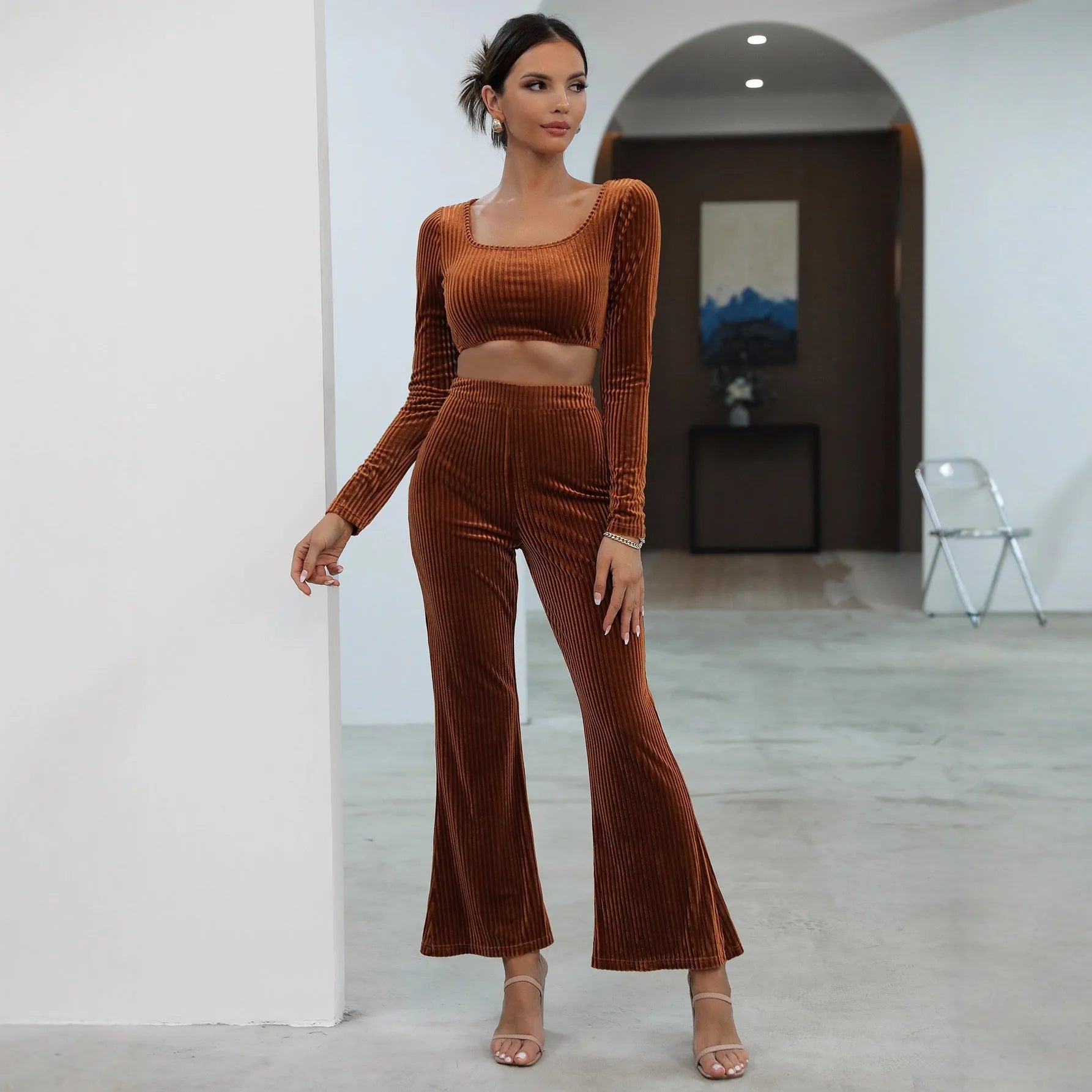 Caramel coloured long sleeve sweater and matching trousers loungewear set on a hanger