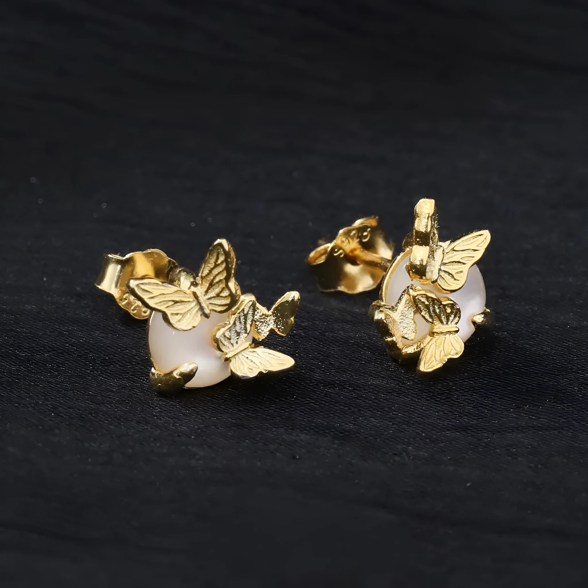 Butterfly ear studs in 925 silver with electroplated gold or white gold finish featuring zodiac modelling