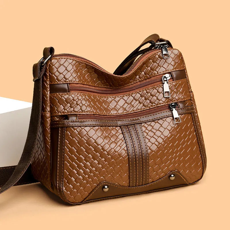 Multi-compartment woven PU leather single shoulder messenger bag in horizontal square shape, brown colour, with zipper change bag interior