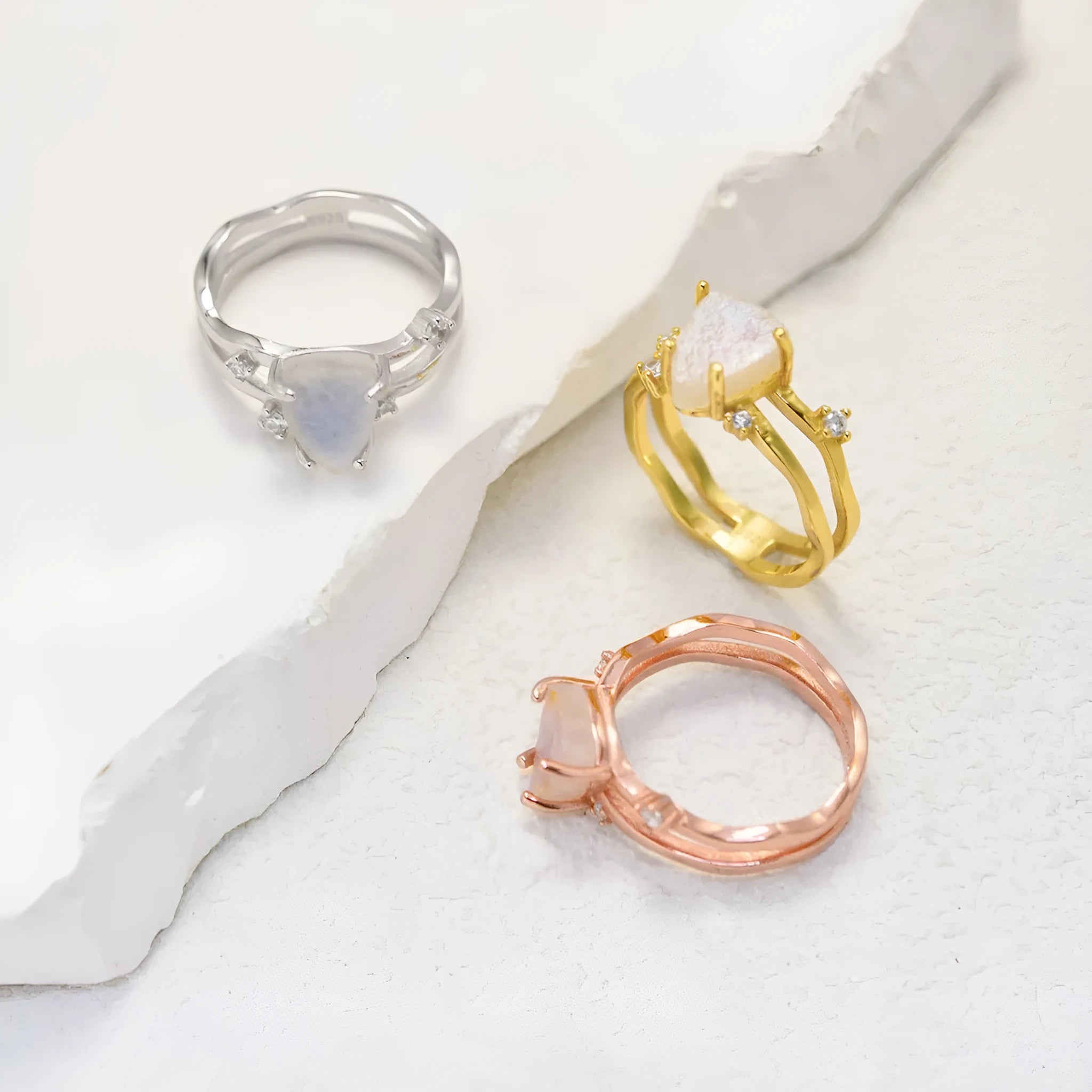 S925 silver geometric ring with irregular triangle design and moonstone, shown in rose gold finish.