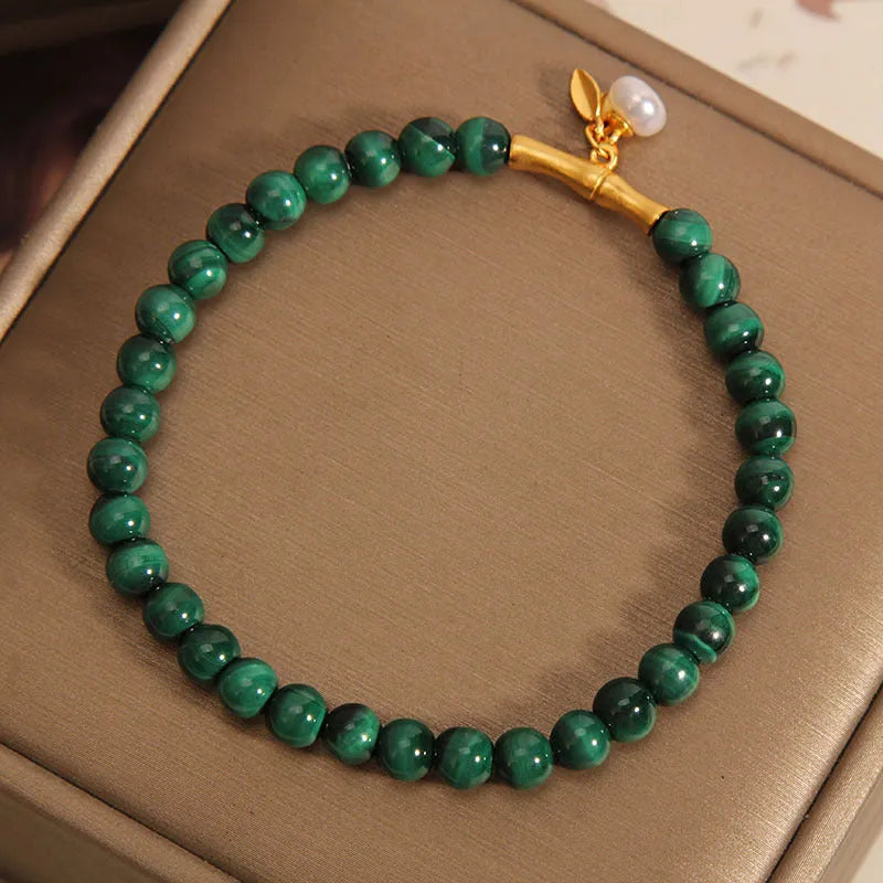 Women's white crystal lucky bamboo bracelet on display