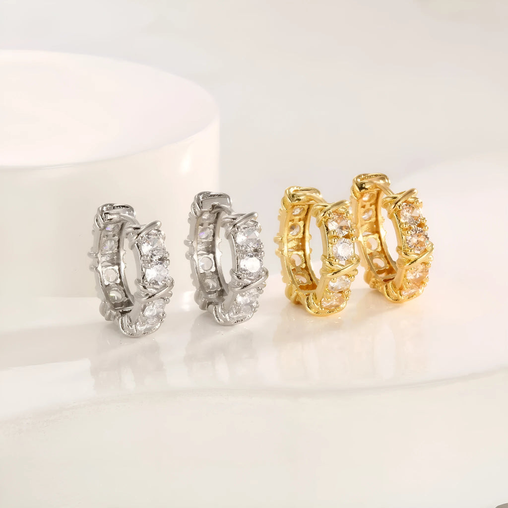 Geometric hexagonal clover cross shape earrings with ellipse detail, shown in gold and silver electroplated colours.