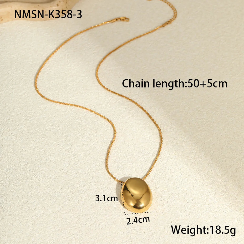 Gold geometric pendant on an adjustable stainless steel necklace chain.