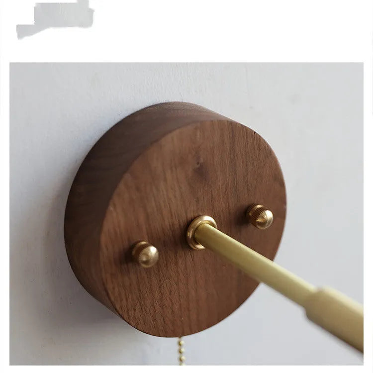 Inn Niche walnut-colour Nordic wall lamp mounted above a bedside table