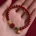 Happy Eyebrow Bracelet made of cinnabar with Emperor Sandstone beads and fu character charm.