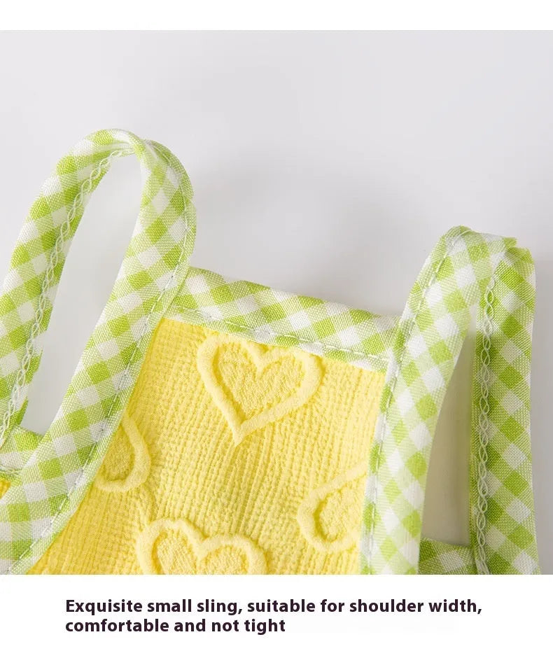 Small dog wearing elastic vest with bow suspenders and heart texture