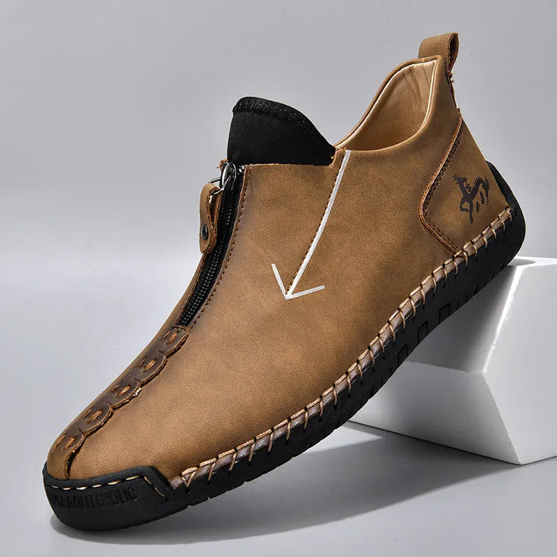 Men's black leather boots with front zipper and hand-stitched detailing on round toe