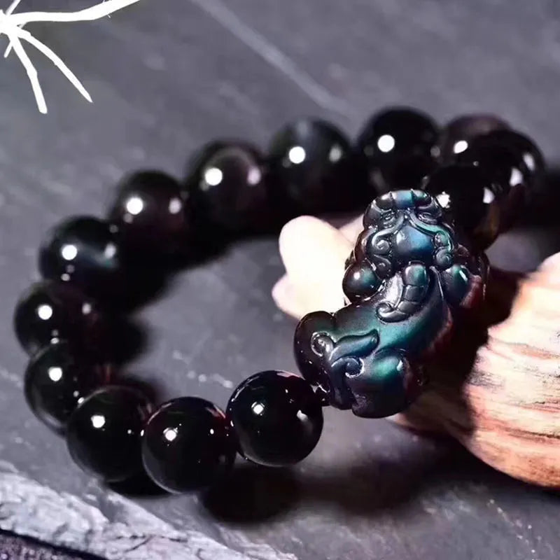 Natural ice colour eye obsidian crystal bead bracelet on a wrist, showing unisex design.