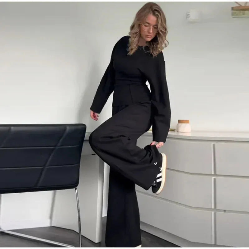 Women's black polyester fleece two-piece suit with long sleeve top and wide-leg trousers
