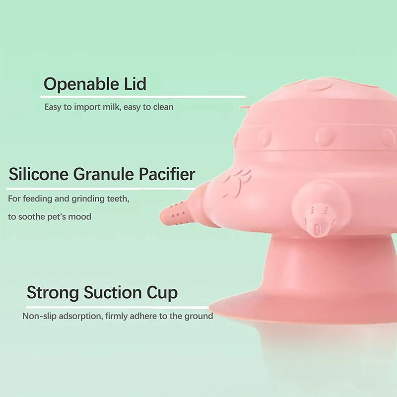 Pink silicone pet nursing bottle with bionic breast-shaped pacifier on a flat base, with three additional pacifiers.