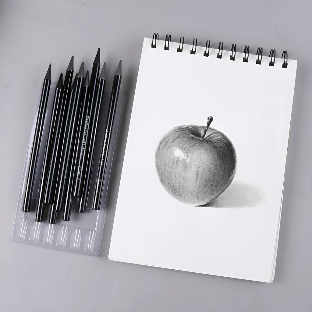 Set of six graphite pencils and three carbonized pencils in wooden casings on suction card packaging.