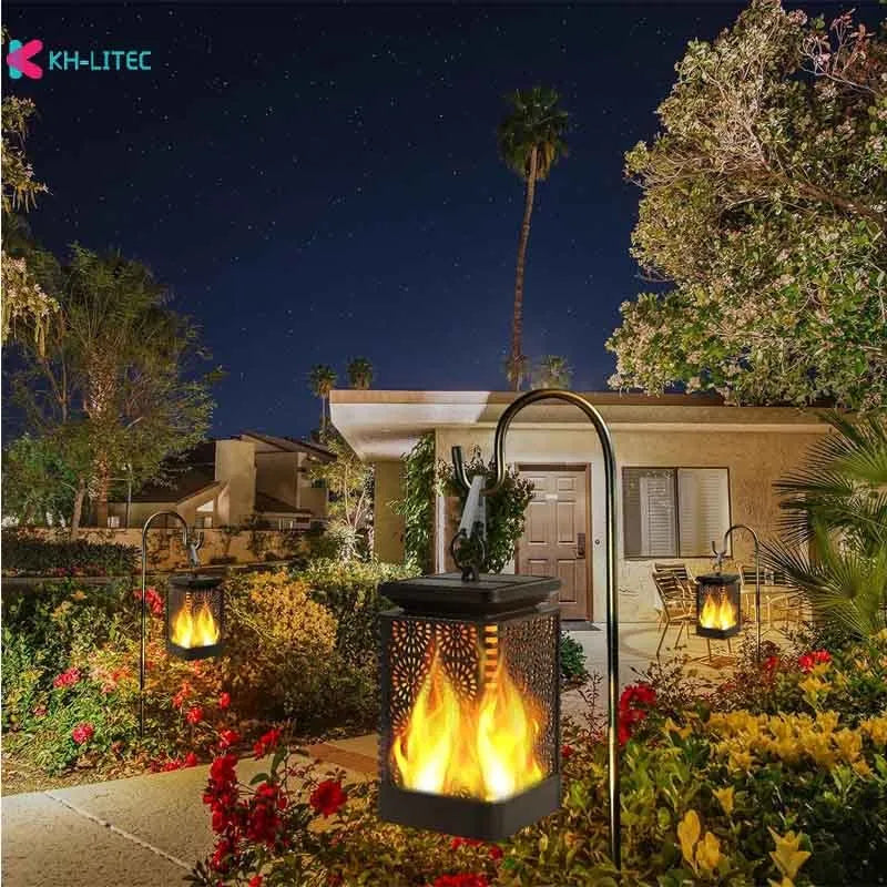 Set of four black solar-powered hanging flame torch lights for outdoor garden decoration.