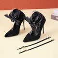 Black pointed toe women's high heel with an ankle buckle strap and a 12cm heel.