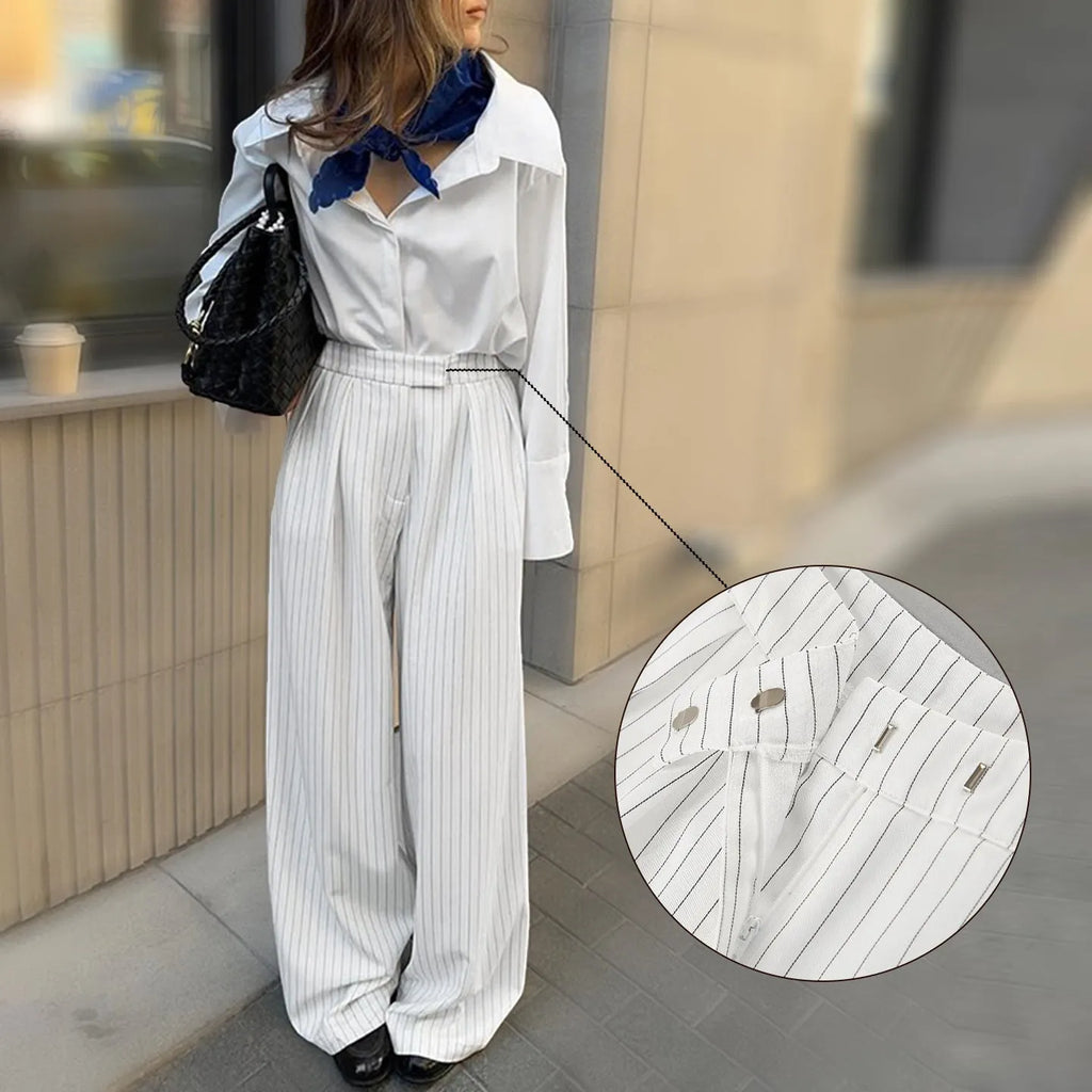 White striped wide-leg trousers with a zip fastening, laid flat.