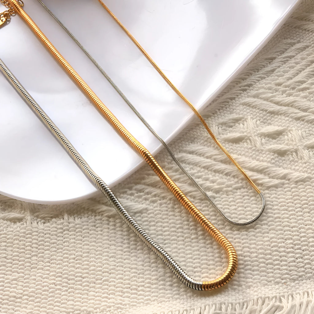 Gold-coloured stainless steel snake bone chain necklace with a 3mm width and geometric design.