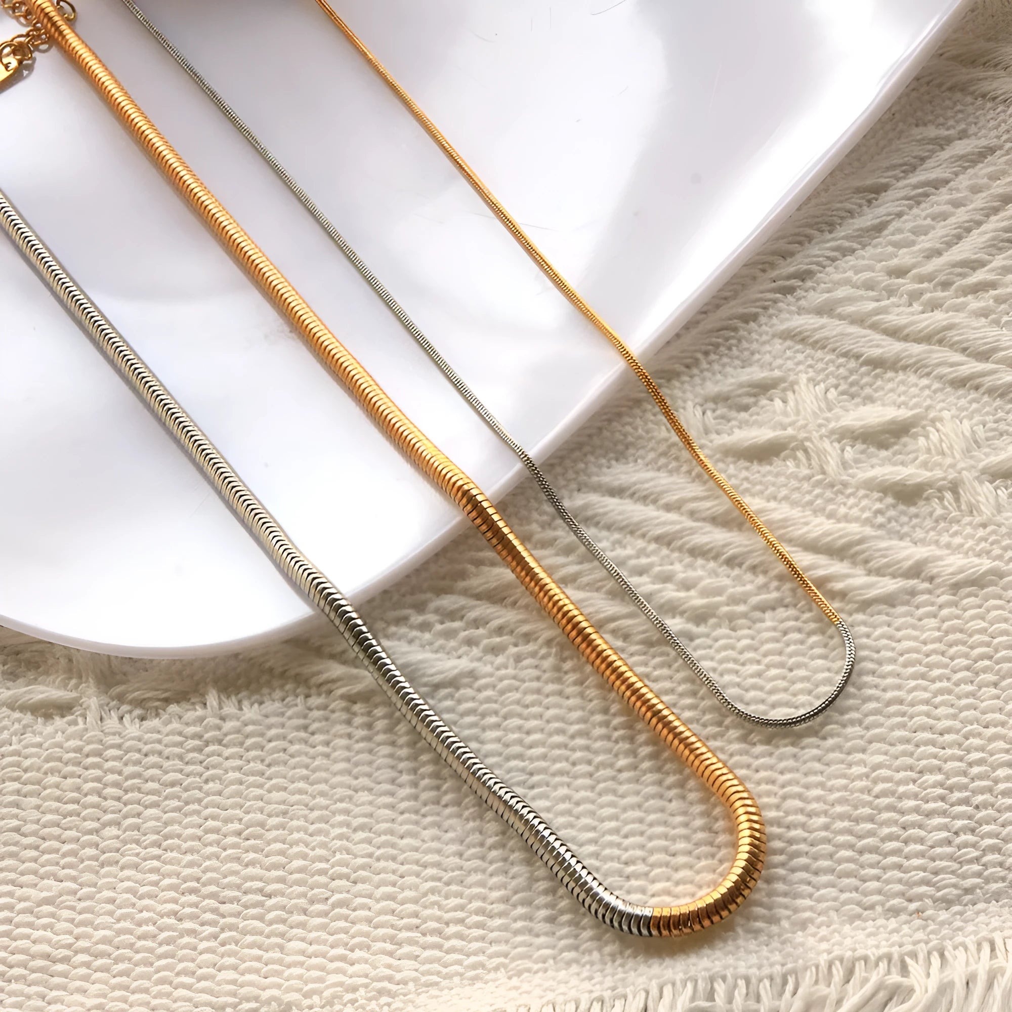 Gold-coloured stainless steel snake bone chain necklace with a 3mm width and geometric design.
