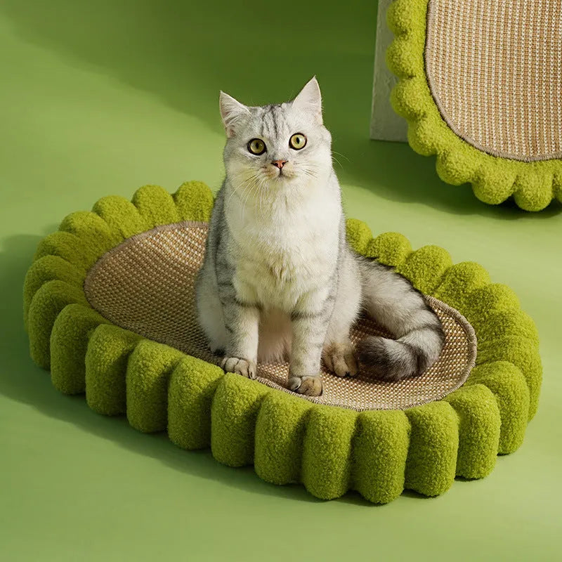 Green oval cat scratch pad and bed made from sisal measuring 650x420x100mm