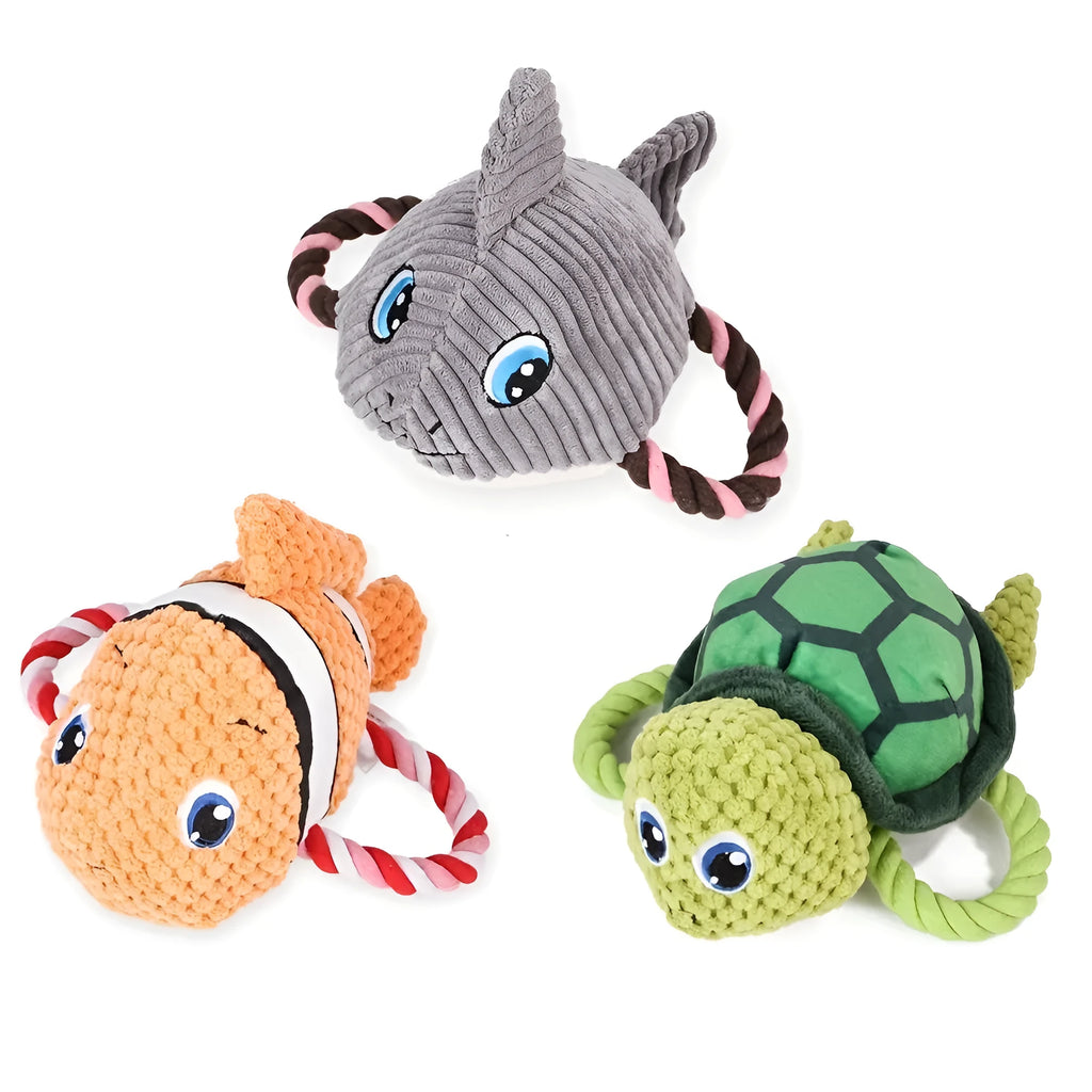 Grey, green, and orange turtle-shaped soft plush dog chew toy with internal knots.