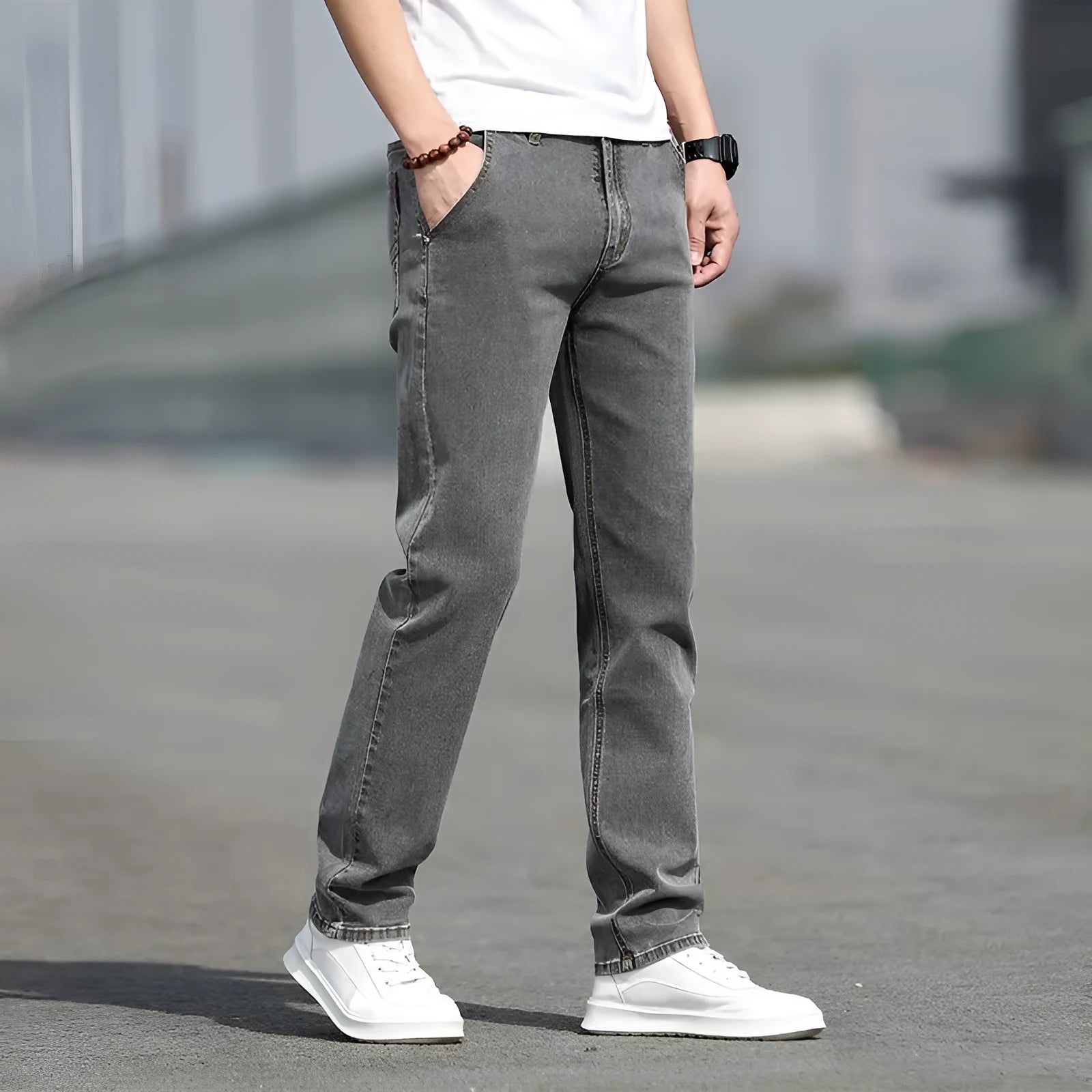Men's smoky grey low waist straight leg jeans with a zipper fly, shown on a hanger.