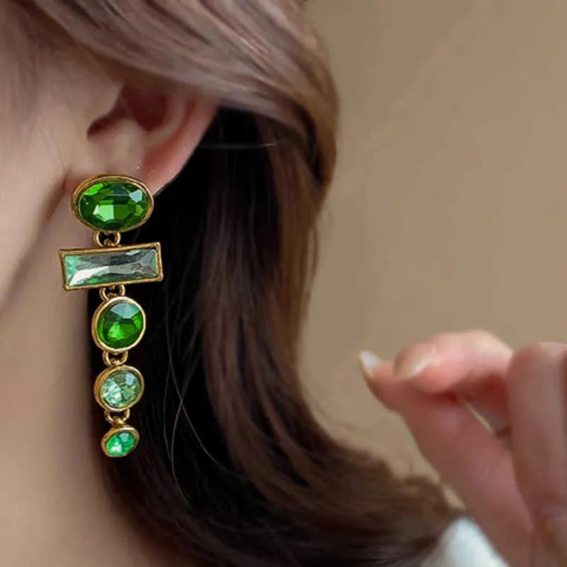 A pair of retro green gradient tassel earrings with inlaid zircon stones in a Chinese geometric style.