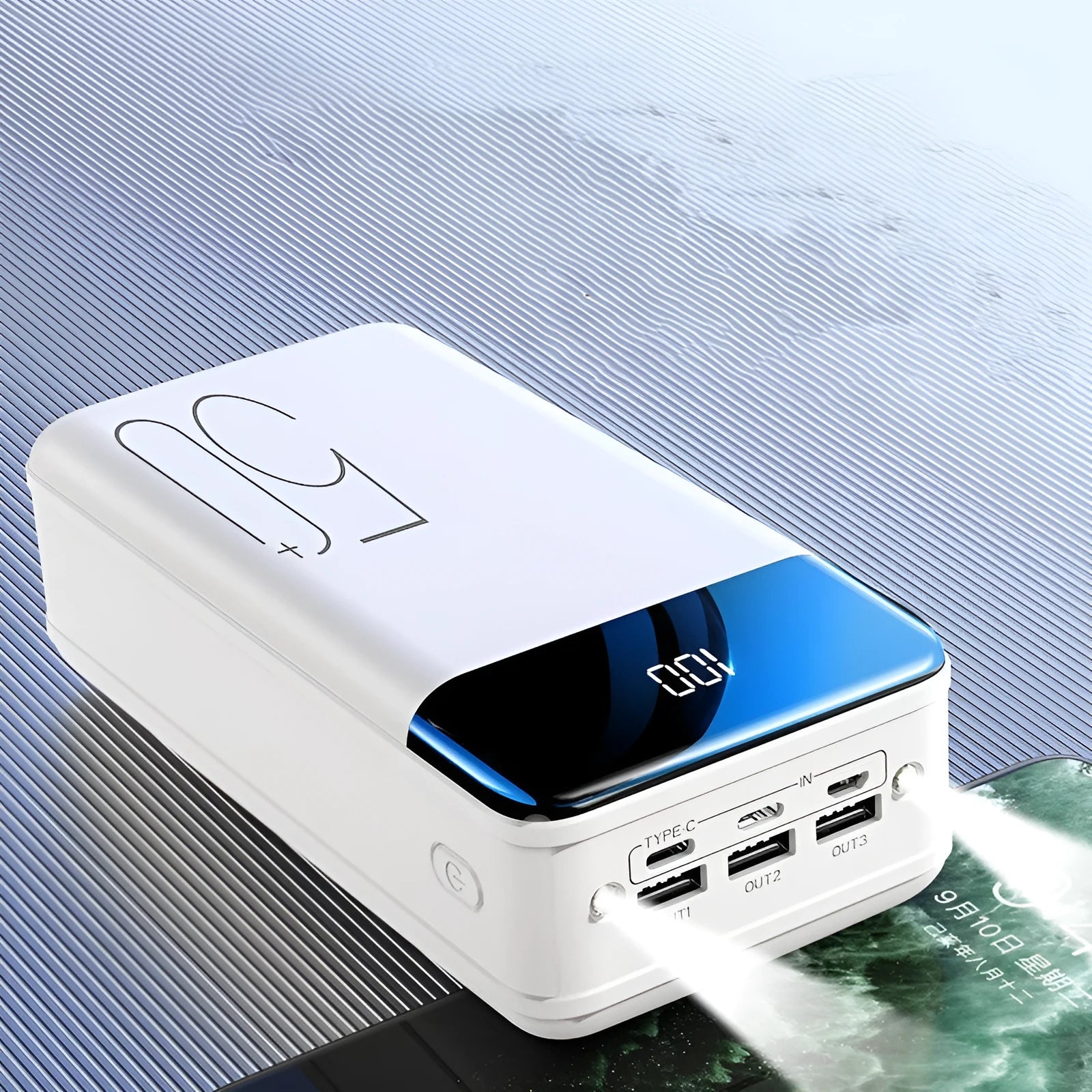 Large black power bank showing three output ports and display screen measuring 169mm