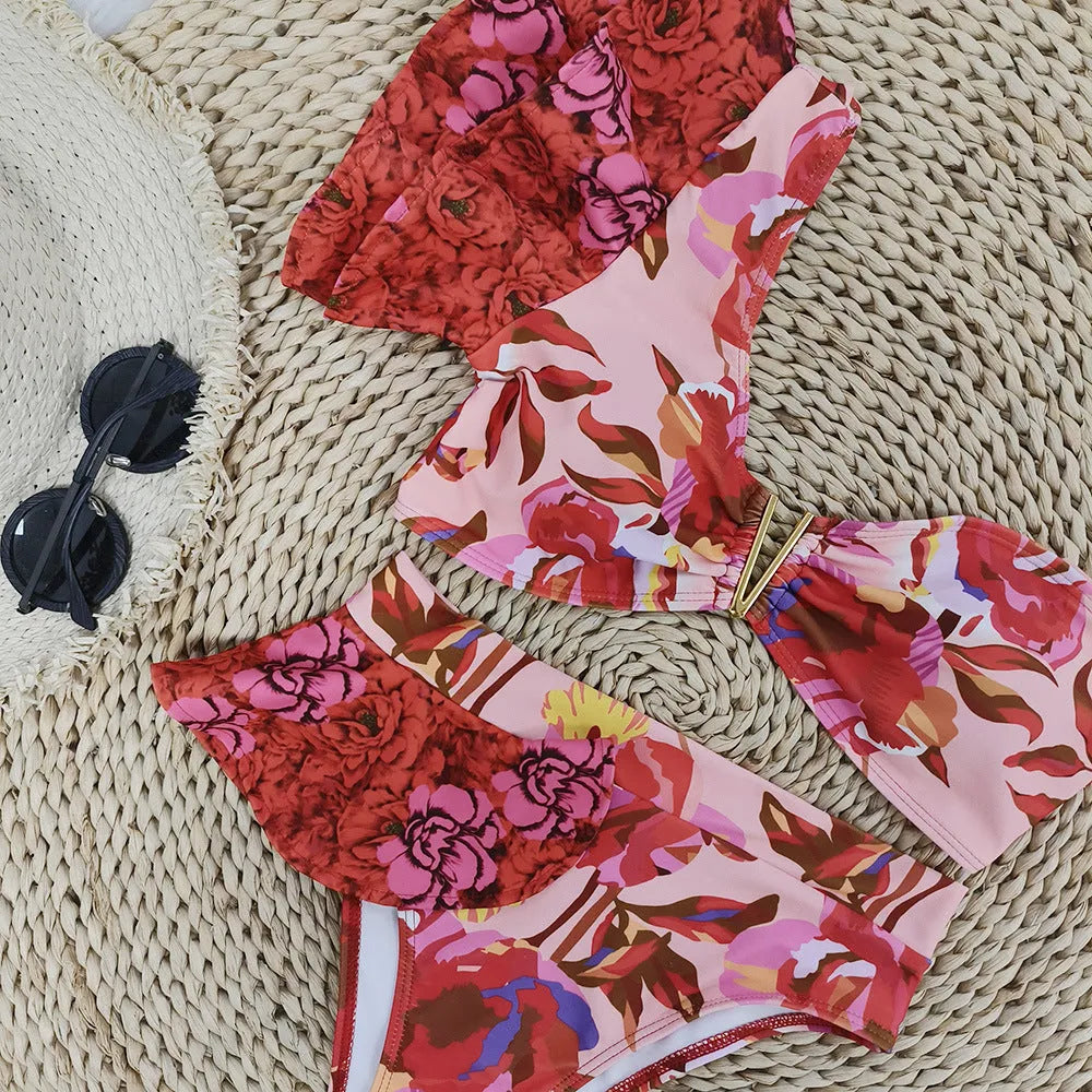 Women's pink one-shoulder ruffled bikini with high-waist briefs and red flower print