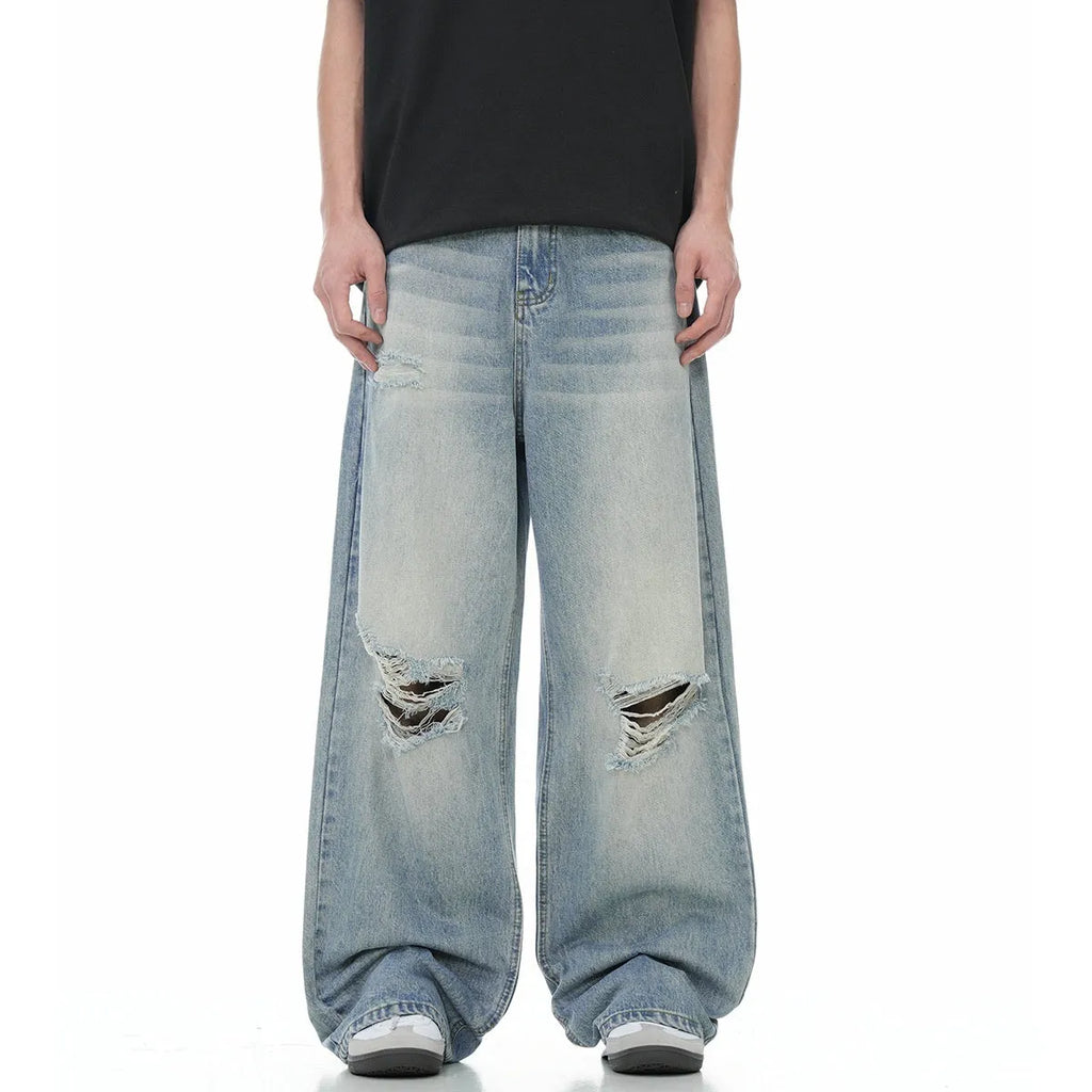 Blue men's retro straight-leg jeans with ripped details and a zipper fly.