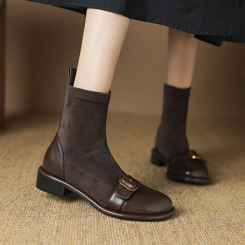 Black women's Martin-style ankle boots with lace-up front, round toe, and low heel on a white background.