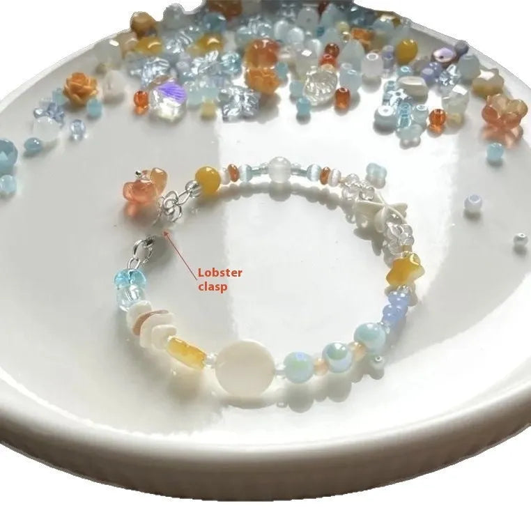 Orange alloy bracelet with diamond-shaped links and mixed material construction
