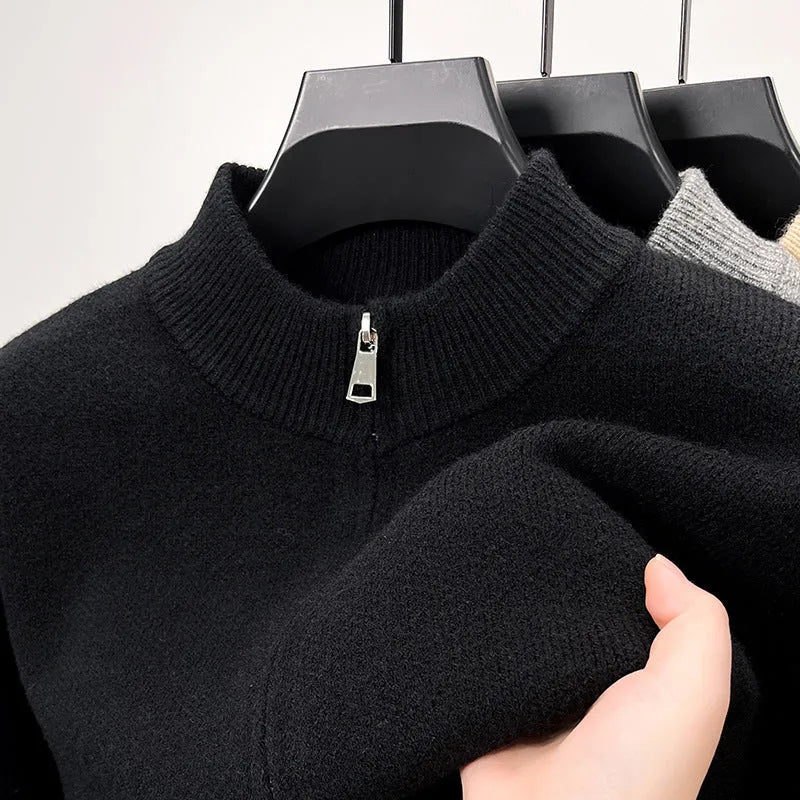 Men's black zip-up knitted cardigan with a stand collar, shown on a model.
