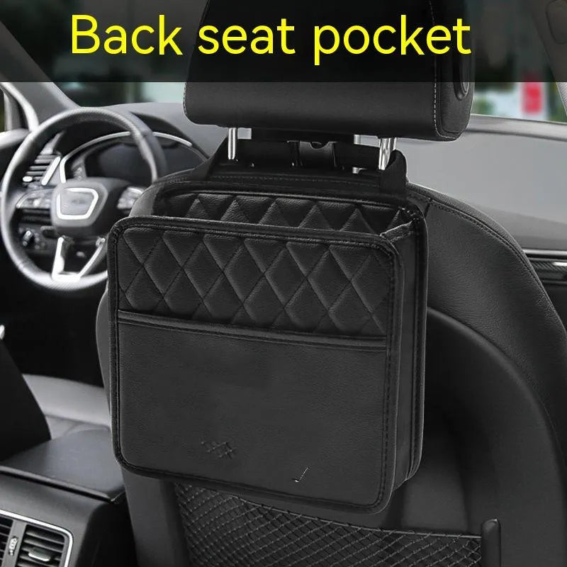 Leather hanging car storage bag and trash can in black, shown mounted behind a car seat