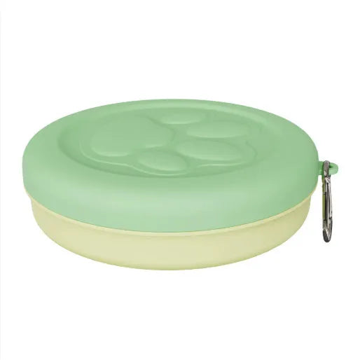 Portable plastic dog food and water bowl in light pink and green colours showing collapsible design for travel