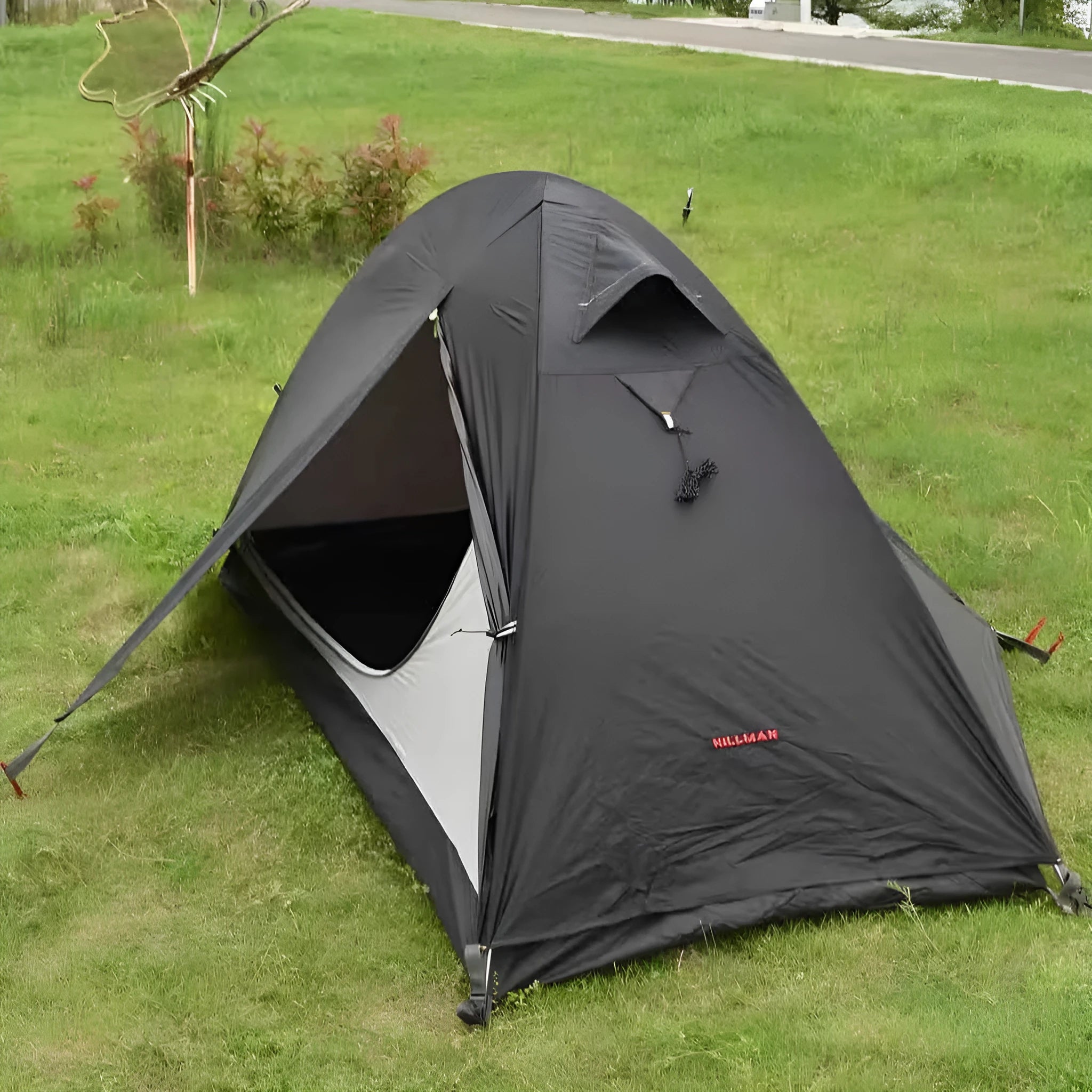 Single person lightweight camping tent with aluminium poles in red colour showing double-layer construction