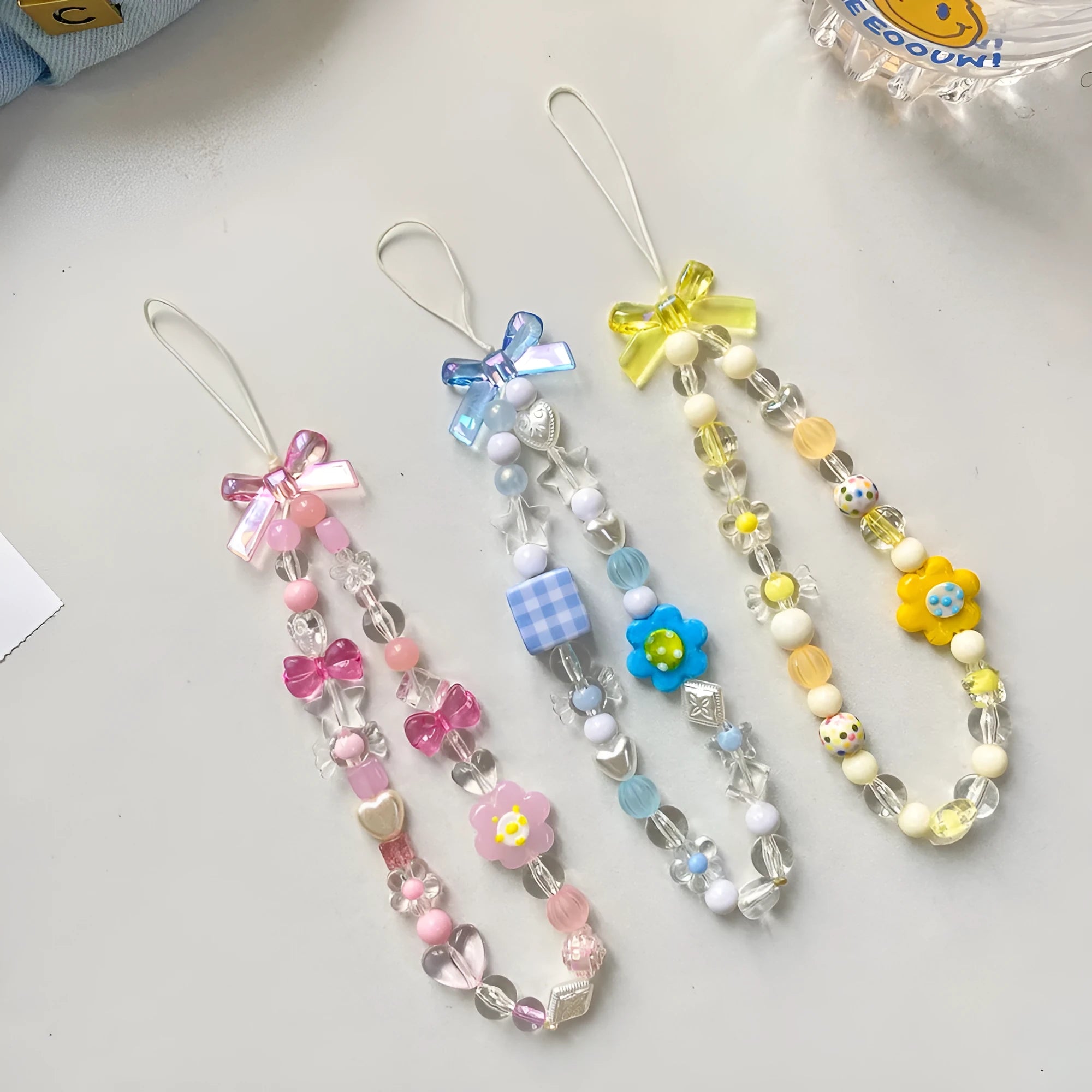 Beaded flower mobile phone lanyard with plastic resin decorative flowers and hand rope strap in blue colour