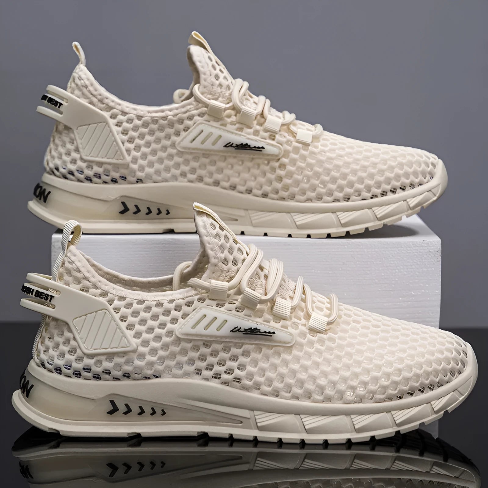 Men's beige casual sneaker with synthetic leather upper and mesh lining, featuring a flat low-heel sole and lace-up front.