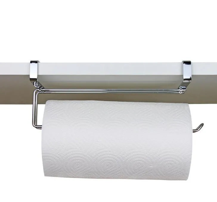 Silver stainless steel paper towel rack hanging on a wooden cabinet door.