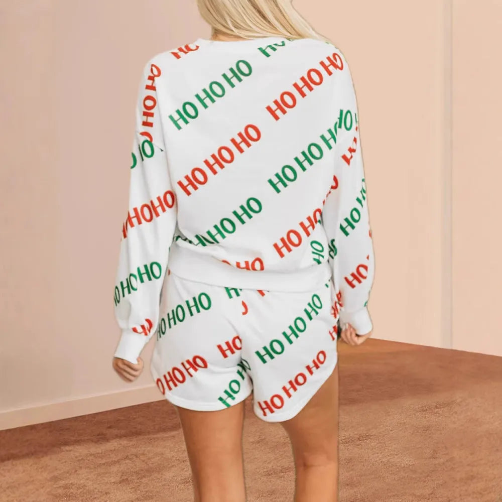 White women's two-piece suit with black letter print, featuring a long-sleeve top and fifth-length trousers.